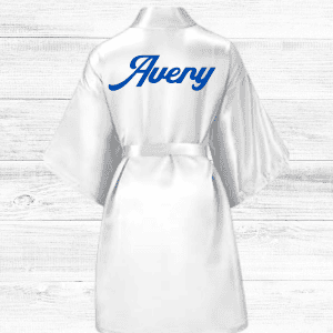 Avery robe with personalized blue script on white satin fabric, perfect for custom fashion or lounge wear.
