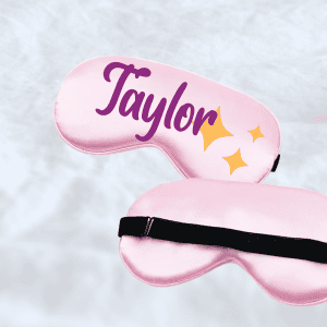 Personalized pink sleep mask with "Taylor" text and star design, perfect for customizable sleep accessories.