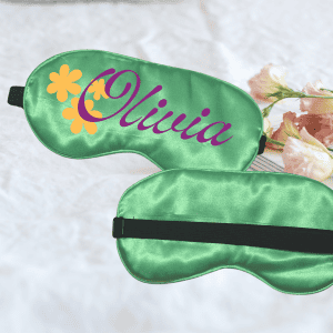 Silk sleep mask with personalized name Olivia in purple and yellow flower design, perfect for relaxing and enhancing sleep quality.